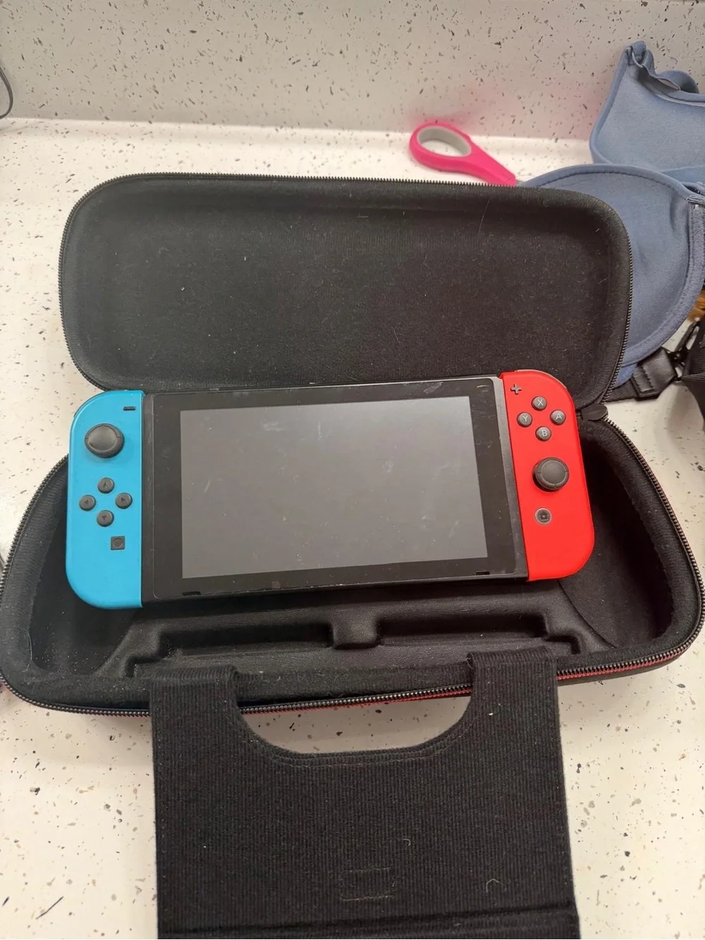 Nintendo Switch with Red and Blue Joy‑Con Controllers and Carry Case